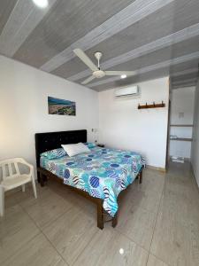 a bedroom with a bed and a ceiling fan at Hotel Sol del Magdalena in La Dorada +7 photos