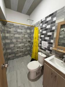 a bathroom with a toilet and a sink at Hotel Sol del Magdalena in La Dorada
