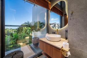 a bathroom with a sink and a large window at U Villas - Tropical Views Luxury Stay with Pool & Workspace in Ungasan
