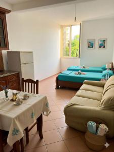 a living room with a couch and a table at Apartments Vila Cala in Durrës