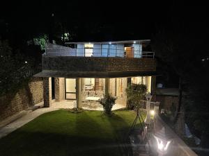 a house at night with lights on the lawn at Heritage Cottage Kashmir Point in Murree +11 photos