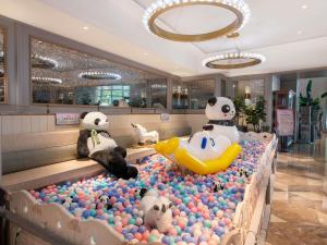 two stuffed panda bears in a pool of balls at Mercure Chengdu Chunxi Taikoo Li -Walk to Pedestrian Street in Chengdu