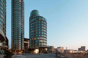 two tall glass buildings in a city at Locke Copenhagen in Copenhagen +56 photos