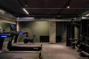 a gym with a treadmill and a exercise bike at Locke Copenhagen in Copenhagen