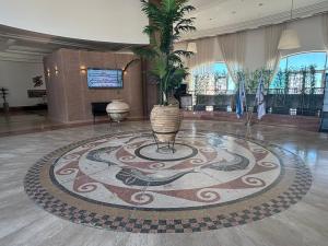 a lobby with a large rug with a plant on it at Azure apartments Haifa in Haifa +17 photos