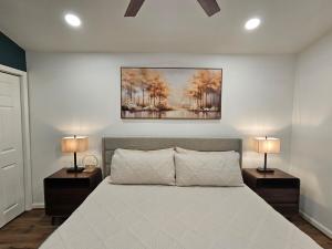 a bedroom with a large bed with two lamps at Tiny Home with Grill Laundry Deck Desk in Phenix City