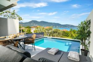 an outdoor patio with a swimming pool and a table and chairs at Ethos Zeen Private Pool Suites in Potamiá