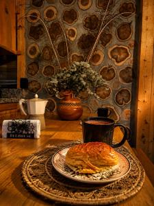a table with a plate of food and a cup of coffee at Beehouse Arví Cabaña in Guarne +25 photos