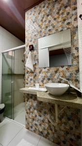 a bathroom with a sink and a mirror at Pousada São José in Barreirinhas +67 photos