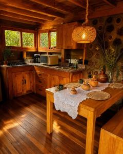 a kitchen with a wooden table in a cabin at Beehouse Arví Cabaña in Guarne