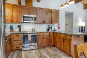 a kitchen with wooden cabinets and stainless steel appliances at Northstar Cabin Escape in Truckee