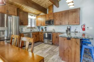 a kitchen with wooden cabinets and stainless steel appliances at Northstar Cabin Escape in Truckee