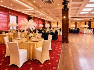 a banquet hall with tables and chairs in a room at Hotel Rostov in Pleven