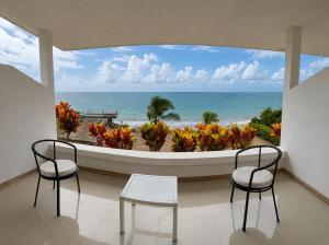 a room with two chairs and a view of the beach at Hotel Punta Blanca - Jama - Manabí in Jama +5 photos