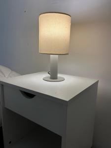 a table with a lamp on top of it at Areal in Areal