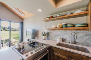a kitchen with a sink and a large window at Lakeview Meadow Retreat in Sisters