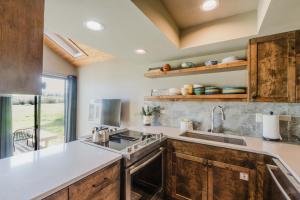 a kitchen with wooden cabinets and a sink at Lakeview Meadow Retreat in Sisters