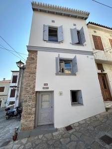 a white building with two windows and a door at Samos Vista Azzurra 1 in Samos