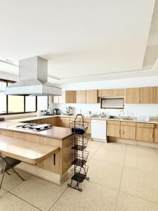a large kitchen with wooden cabinets and a stove top oven at Casa Bosques in Mexico City