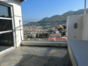 a view of a city from an open window at Samos Vista Azzurra 1 in Samos