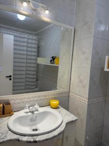 a bathroom with a sink and a mirror at Ofir Guest House in Fão +17 photos