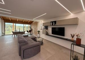 a living room with a couch and a flat screen tv at Villa Heaven Sperlonga in Itri