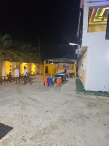 a group of tables and chairs on the beach at night at The Maison Lodge in Ijegun