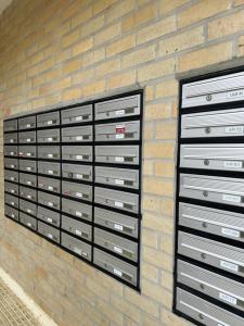 a brick wall with three metal file chests at Ofir Guest House in Fão