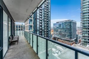an apartment balcony with a view of a city at Altitude Residences in Toronto