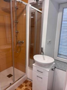 a bathroom with a sink and a shower at Family in Envie +34 photos