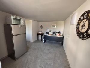 a small room with a refrigerator and a counter at Family in Envie