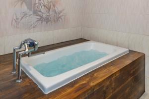 a bath tub with a faucet in a bathroom at HOTEL Lien in Ashiya +27 photos
