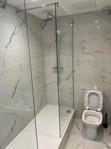 a bathroom with a toilet and a glass shower at Venue Apartment in Colne +9 photos