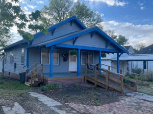 a blue house with a porch with a wooden ramp at Inviting 3 Bedroom Home in Norton