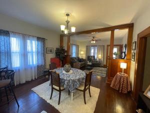 a dining room with a table and chairs in a living room at Inviting 3 Bedroom Home in Norton