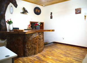 a room with a large wooden counter in a room at St. Patrick’s Forest House in Entebbe +5 photos