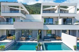 an image of a house with a swimming pool at Videre Golden Private Pool Suites in Potamiá