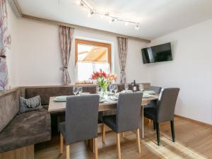 a dining room with a table and chairs and a couch at Apartment Birgit in Zellberg