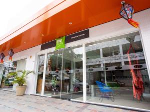 a store front with glass doors and chairs in it at ibis Styles Campina Grande in Campina Grande