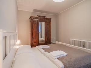 a bedroom with a bed with a dresser and a mirror at Kitz Apartments Top 1 in Kitzbühel