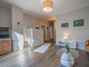 a living room with a table and a tv at Kitz Apartments Top 1 in Kitzbühel +11 photos