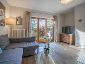 a living room with a couch and a tv at Kitz Apartments Top 1 in Kitzbühel