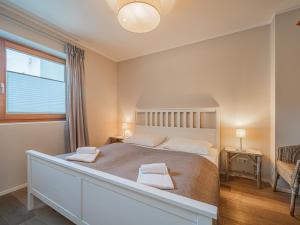 a bedroom with a large bed with two towels on it at Kitz Apartments Top 6 in Kitzbühel