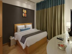 Säng eller sängar i ett rum på Melange Luxury Serviced Apartments