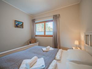 a bedroom with a bed with towels and a window at Kitz Apartments Top 7 in Kitzbühel