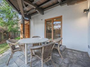 a patio with a table and chairs on a porch at Kitz Apartments Top 1 in Kitzbühel