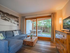 a living room with a couch and a tv at Kitz Apartments Top 6 in Kitzbühel