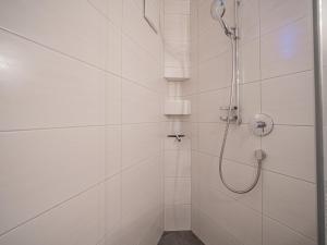 a bathroom with a shower with a shower head at Kitz Apartments Top 6 in Kitzbühel +16 photos