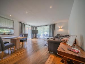 a living room with a couch and a table at AlpenHerz in Jochberg