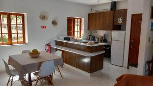 a kitchen with a table and a counter top at Monte da Cardela Nova in Melides